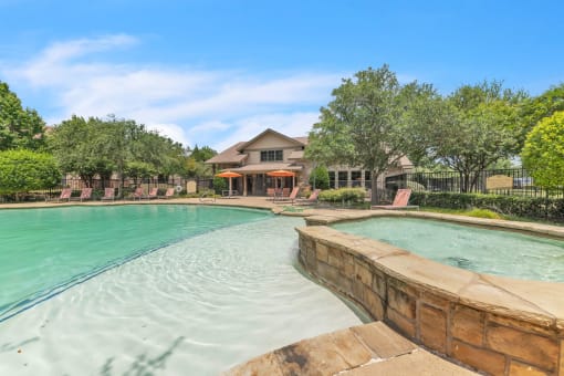 a swimming pool with a house in the background