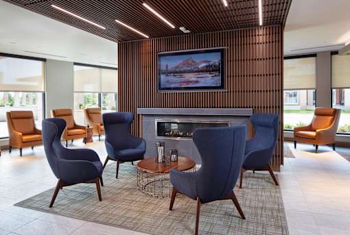 A living room with a television and a fireplace.
