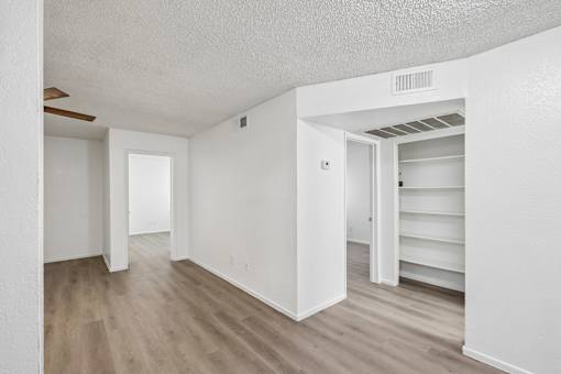 A room with white walls and wooden flooring.