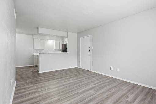 A room with a wooden floor and white walls.