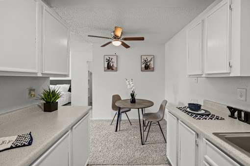 A small kitchen with a table and chairs.