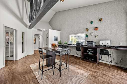 A modern kitchen with a dining table and chairs in the foreground.