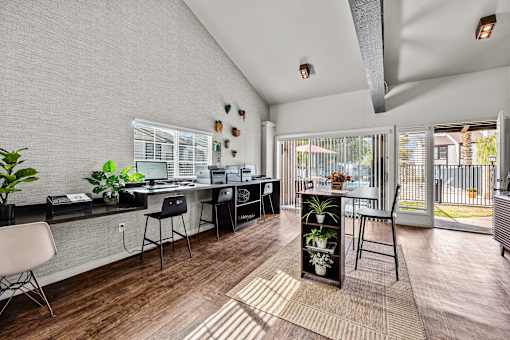 A modern kitchen with a dining table and chairs.