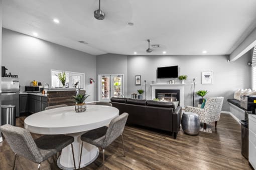 a living room with a table and chairs and a fireplace