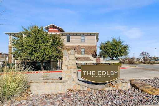 The Colby at Castle Hills is a modern building with a stone entrance.