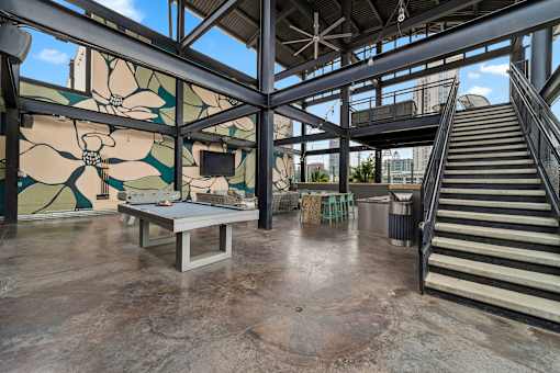 A large open space with a staircase and a table.