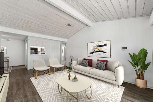 A living room with a white couch, a coffee table, and a painting on the wall.