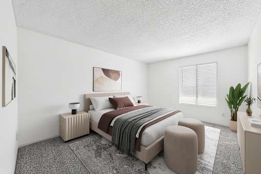 A bedroom with a large bed and a small table with a plant on it.