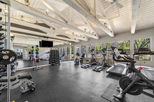 A spacious gym with a variety of exercise equipment.