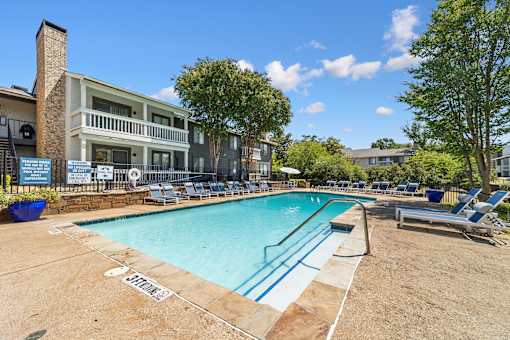 A pool with a blue line in the middle and a sign that says "STOP" on the ground.