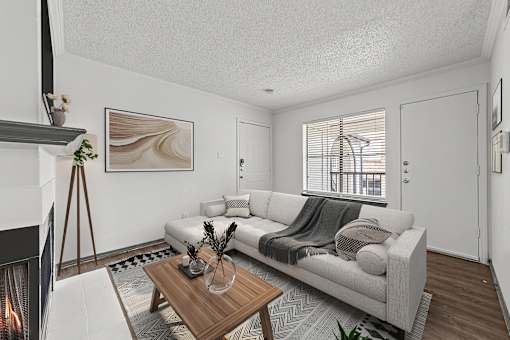 A modern living room with a fireplace and a large painting on the wall.