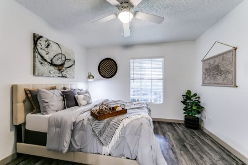 an attic bedroom with a bed and a ceiling fan