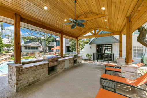 a covered patio with a bar and a pool