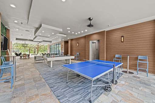 a game room with ping pong tables and a pool table