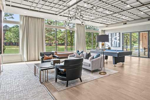 a living room with couches and a pool table