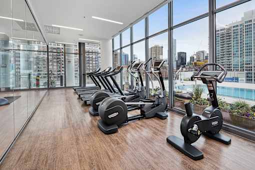 A gym with treadmills and exercise bikes.