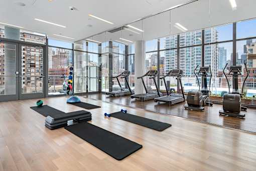 A gym with a view of the city outside the windows.