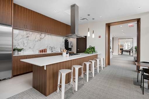A modern kitchen with a long island and bar stools.