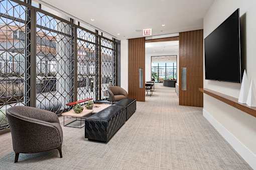 A modern living room with a large window and a flat screen TV.