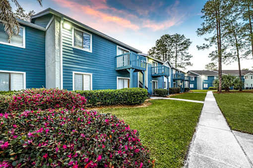 A blue building with a white walkway in front.