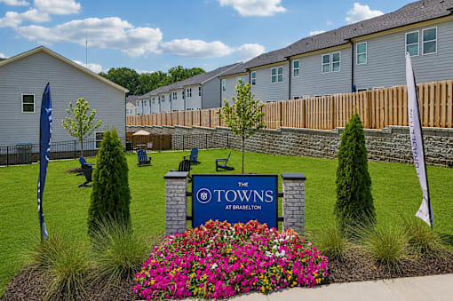 A sign that says "The Towns" is in front of a building.