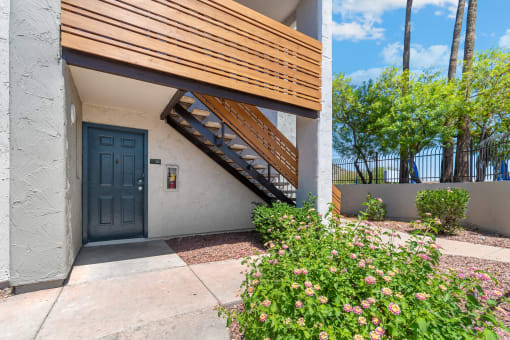 the front door of a building with a staircase leading up to it