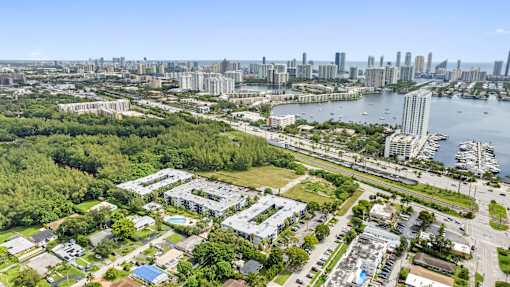 A bird's eye view of a city with a large body of water in the foreground.