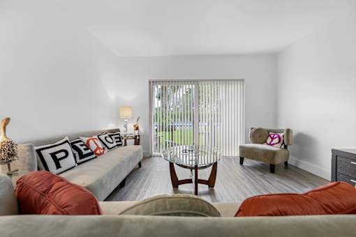 A living room with a grey couch and a chair.