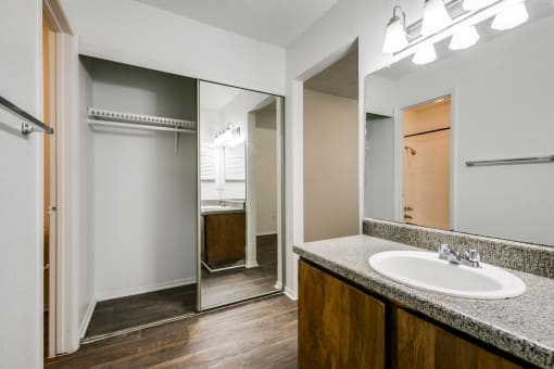 the interior of a bathroom with a sink and a mirror