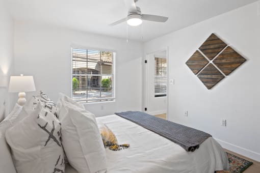 a bedroom with a large bed and a ceiling fan