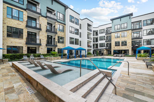 a swimming pool in front of an apartment building