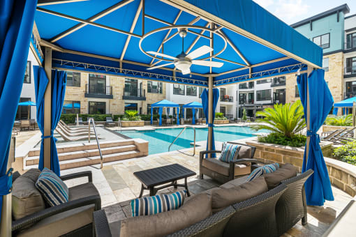 the preserve at ballantyne commons pool and patio area with blue umbrellas