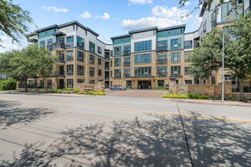 a large apartment building with a street in front of it