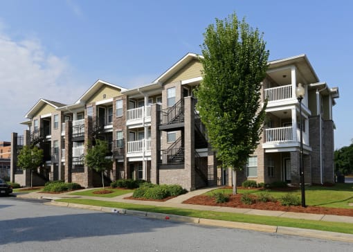 an apartment building with a street in front of it