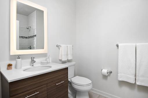 A white toilet sits next to a sink in a bathroom.