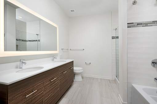 A white bathroom with a sink, toilet, and bathtub.