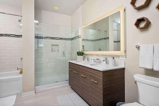 A modern bathroom with a glass shower and a white sink.