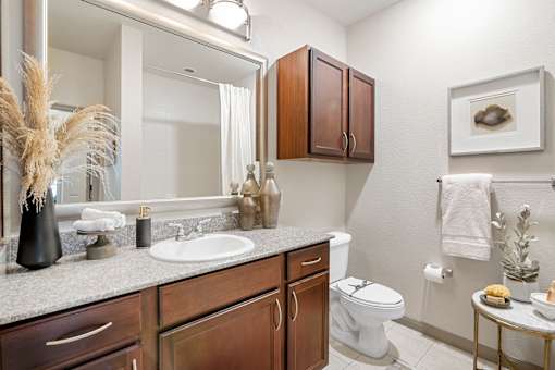 A bathroom with a white toilet and a white sink.