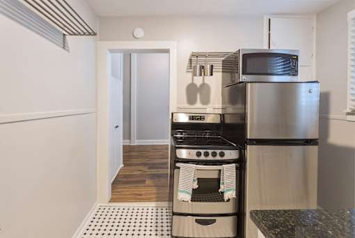A kitchen with a stove top oven and microwave.