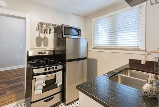 A kitchen with a black and white checkered floor.