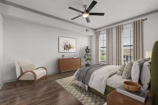 A bedroom with a bed, chair, and a painting on the wall.