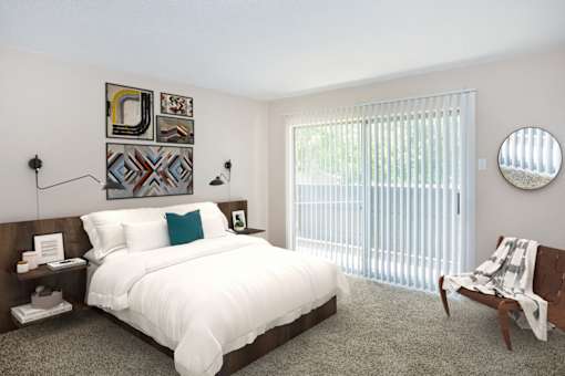 A bedroom with a large bed and a chair.