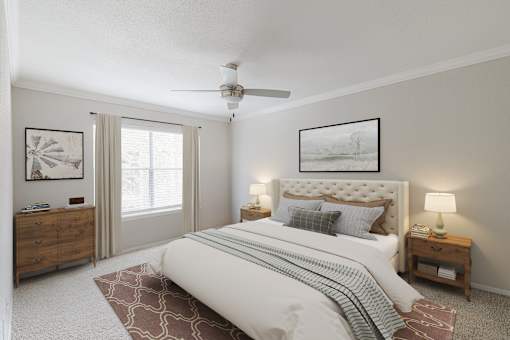 A bedroom with a large bed, a ceiling fan, and a dresser.