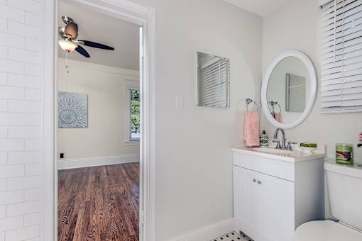 A bathroom with a white sink and a white tub.