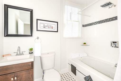 A white toilet sits next to a sink in a bathroom.