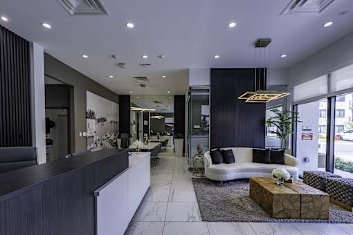 A modern living room with a white sofa and a coffee table.