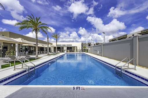 A large indoor swimming pool with a 5 FT depth marker.