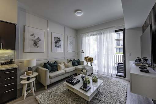 A living room with a couch, coffee table, and pictures on the wall.