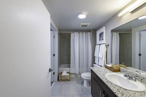 A bathroom with a white sink and a white toilet.