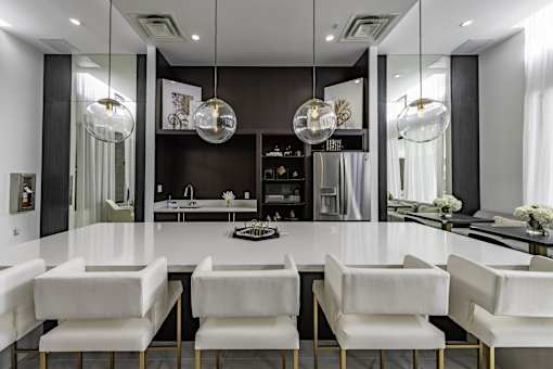 A modern dining room with a large table and chairs.